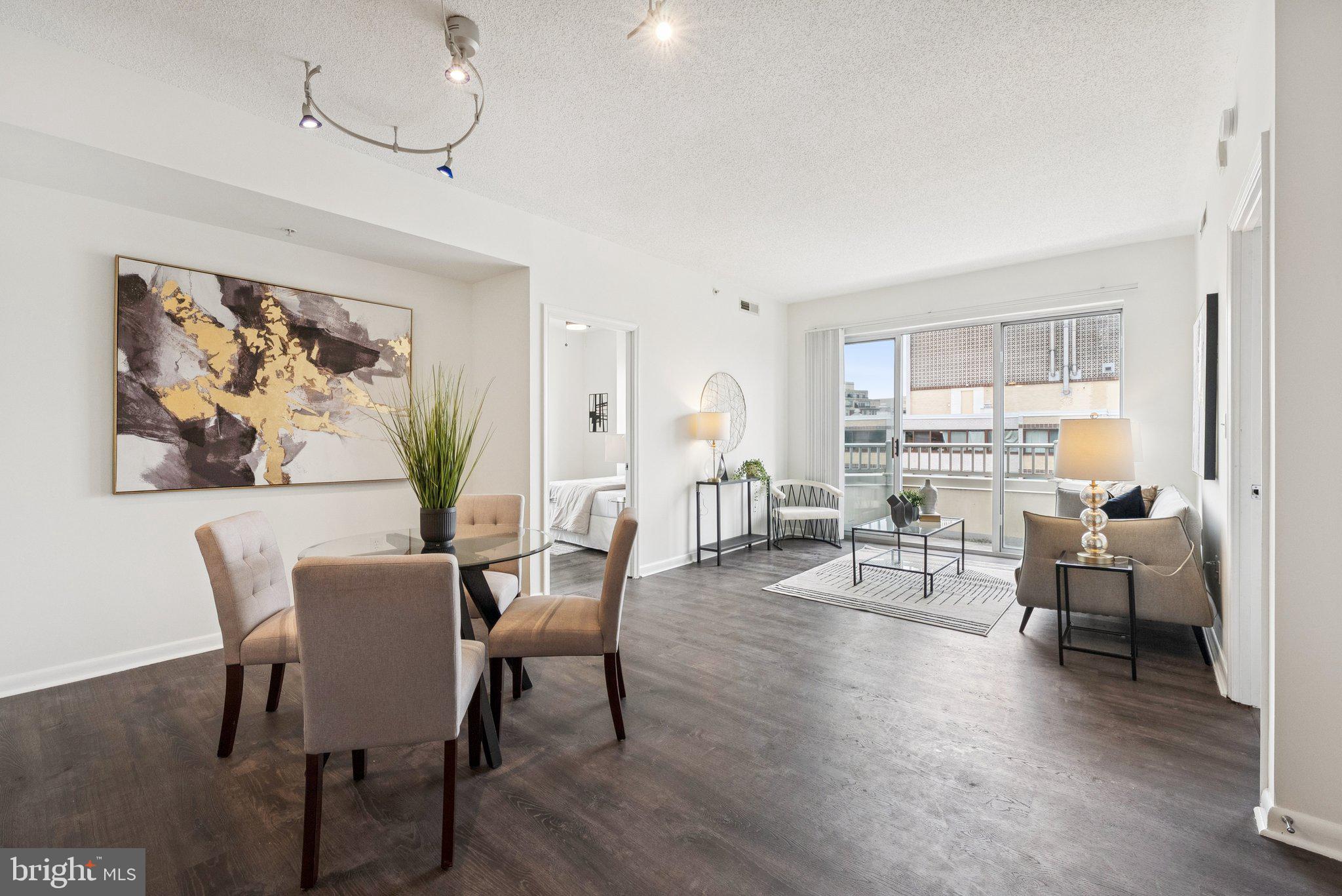 1111 11th Street Northwest, Unit 901 Washington, DC 20001 - Photo 6 of 24 a view of a dining room with furniture window and wooden floor