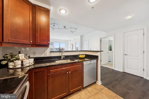 a kitchen with stainless steel appliances granite countertop a sink stove and cabinets