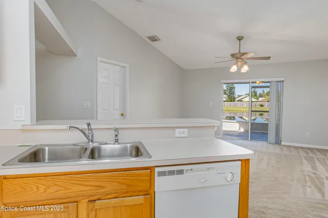 a kitchen with a sink cabinets and window