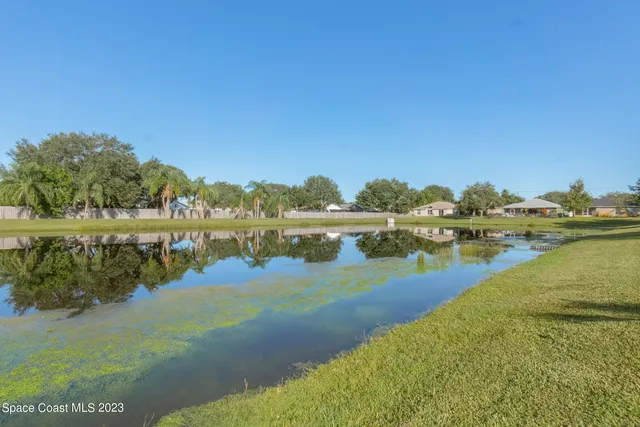 a view of a lake with houses in the background