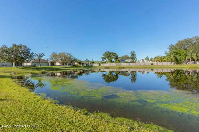 a view of a lake with houses in the back