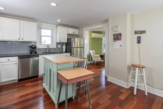 a kitchen with a table chairs refrigerator and cabinets