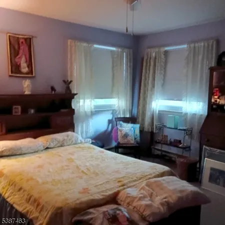 a bedroom with a bed and a mirror