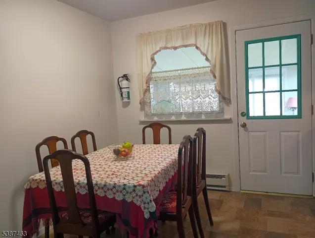 a dining room with furniture and window
