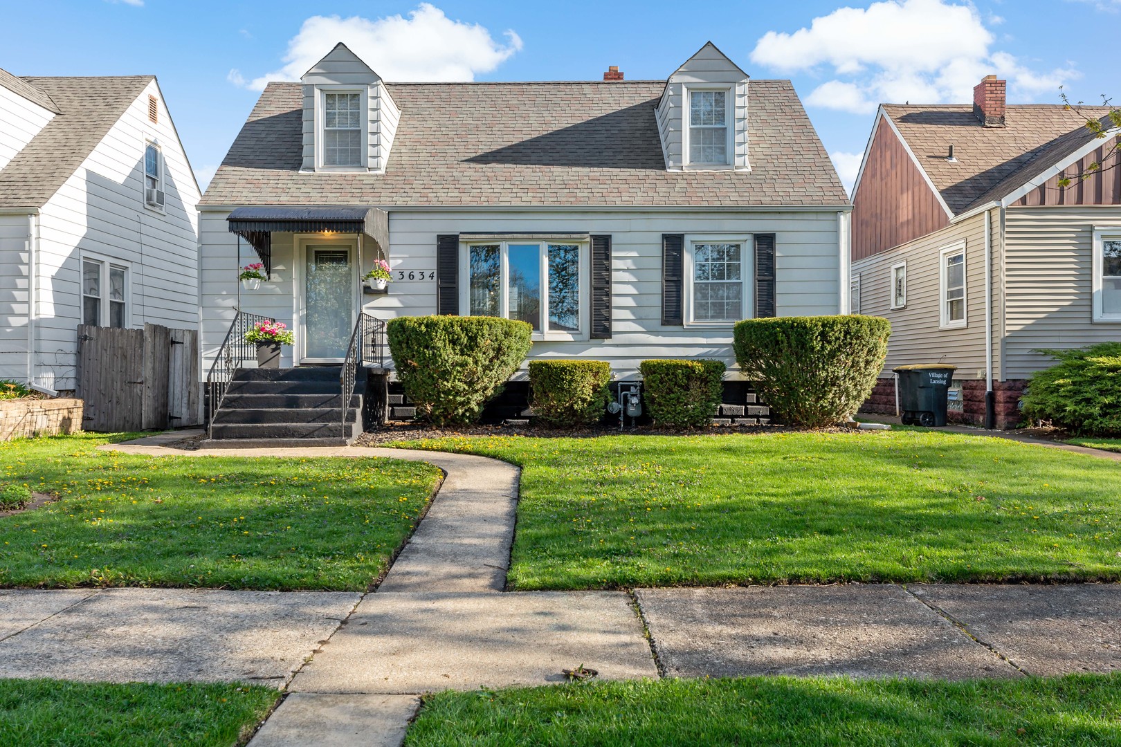a front view of a house with a garden