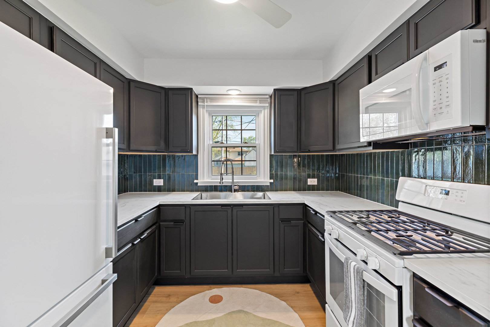 3634 177th Street Lansing, IL 60438 - Photo 5 of 15 a kitchen with a sink a stove and cabinets