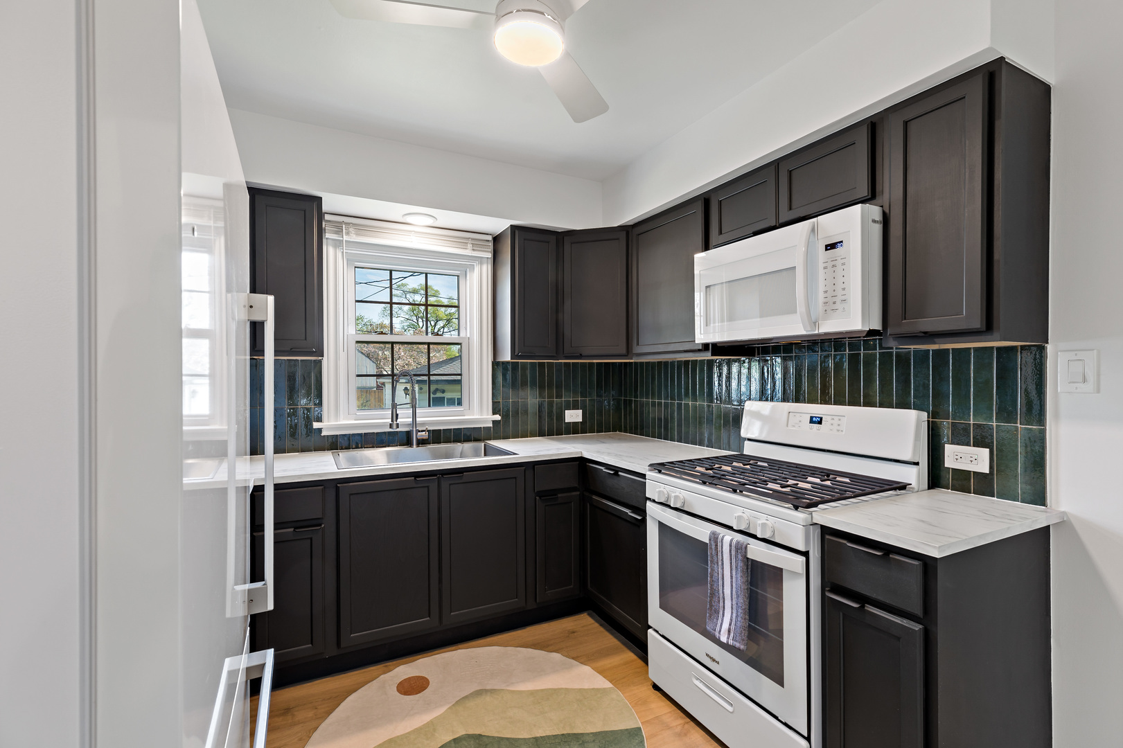 3634 177th Street Lansing, IL 60438 - Photo 6 of 15 a kitchen with a stove a sink and a microwave