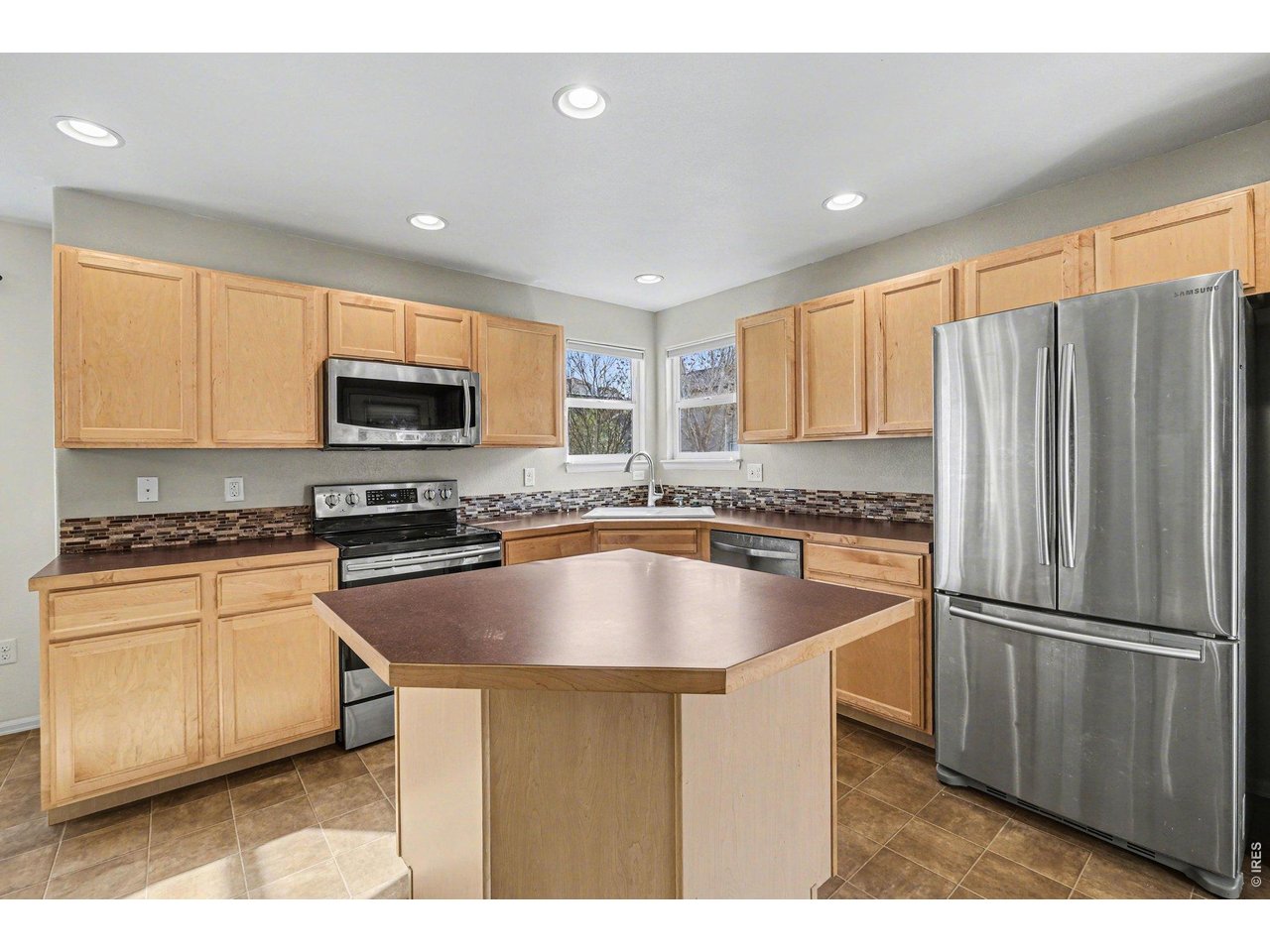 7347 Atlantis Street Wellington, CO 80549 - Photo 4 of 23 Kitchen with stainless steel appliances all included