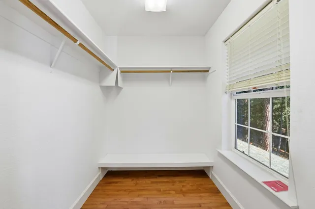 a view of walk in closet with empty racks