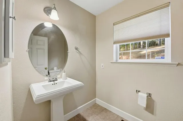 a bathroom with a sink a mirror and a vanity