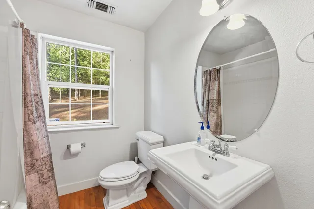 a bathroom with a sink toilet and a mirror
