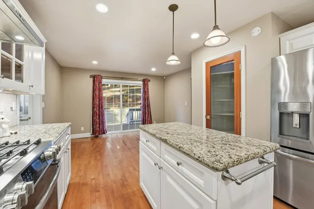 a kitchen with stainless steel appliances granite countertop a stove and a refrigerator