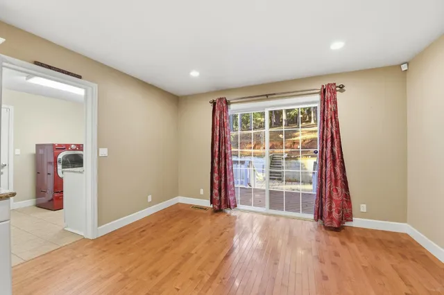 an empty room with wooden floor and closet