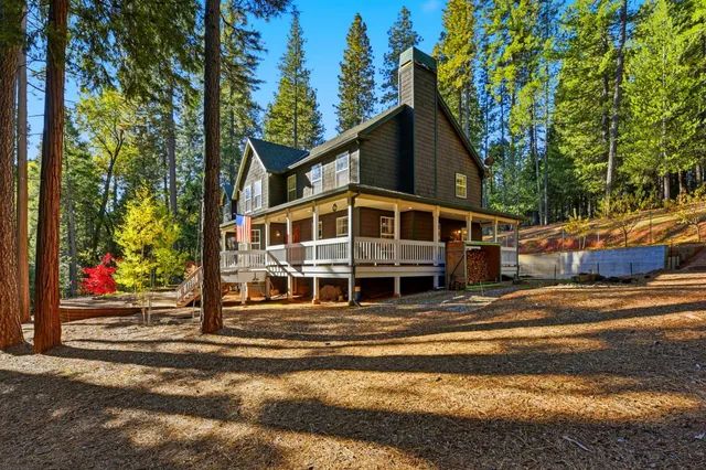 a view of a house with a large windows and large trees