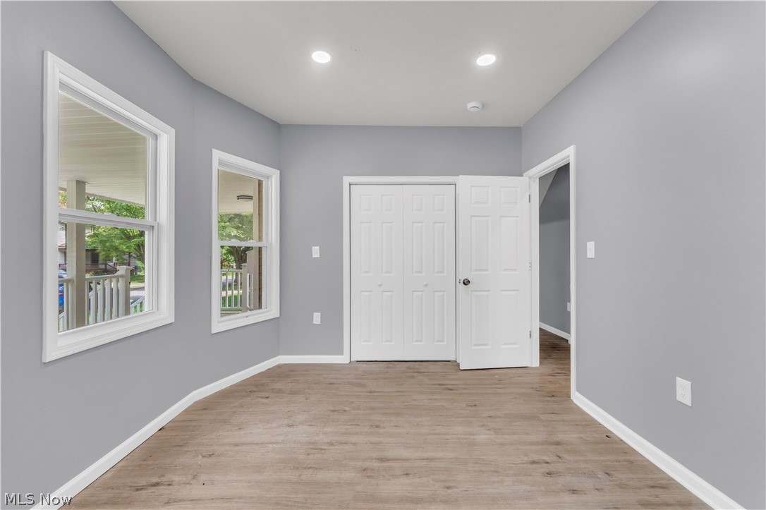 3925 Riverside Avenue Cleveland, OH 44109 - Photo 10 of 46 Room with wood-finish flooring, recessed lighting, double-pane windows, and a bi-fold closet door