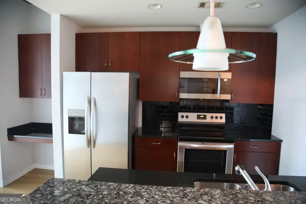 a view of a kitchen with a stove and refrigerator