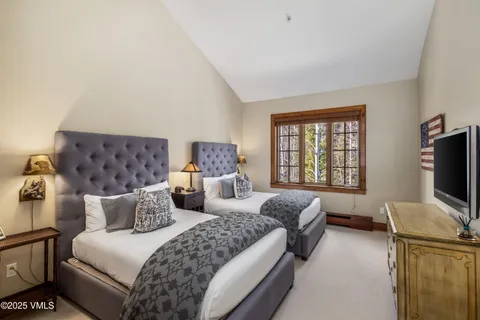 a bedroom with bed couch and window