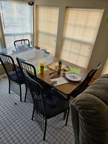 a view of a dining room with furniture and window