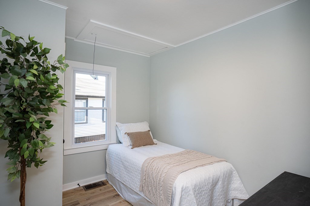 127 Pinehurst Drive Wareham, MA 02571 - Photo 17 of 40 a bedroom with a bed and a potted plant