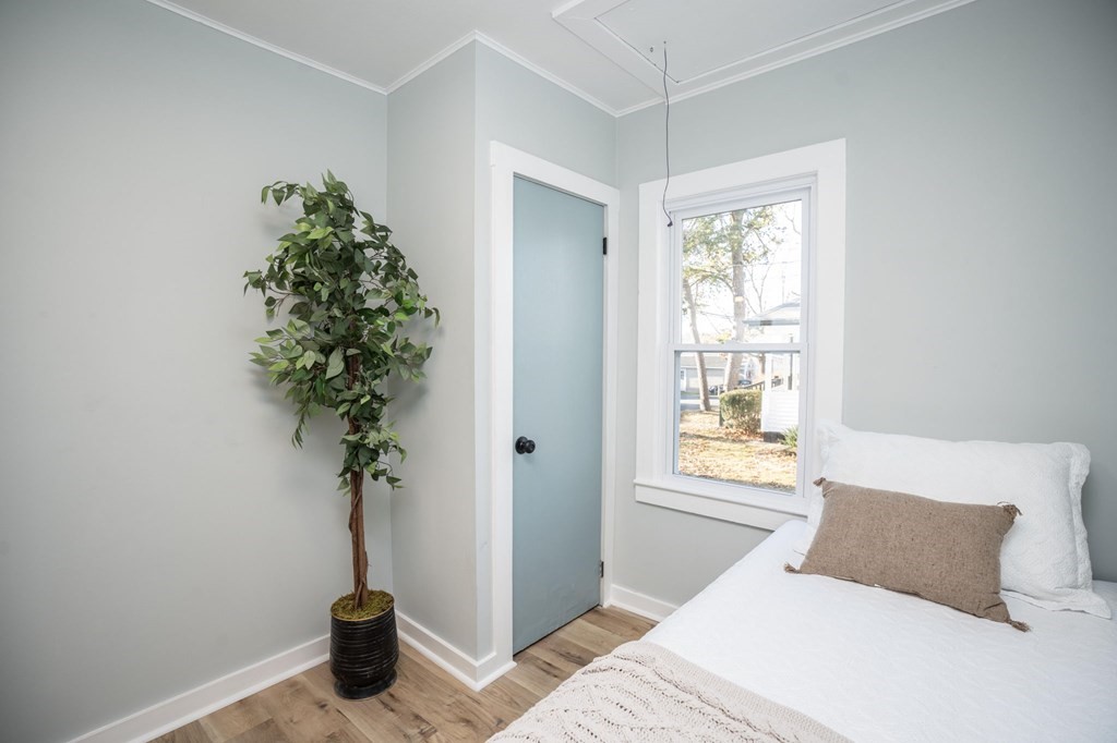 127 Pinehurst Drive Wareham, MA 02571 - Photo 18 of 40 a bedroom with a bed and a potted plant