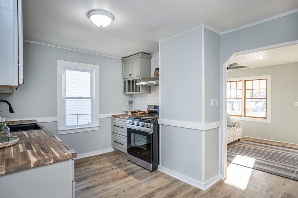 127 Pinehurst Drive Wareham, MA 02571 - Photo 24 of 40 a kitchen with cabinets and wooden floor