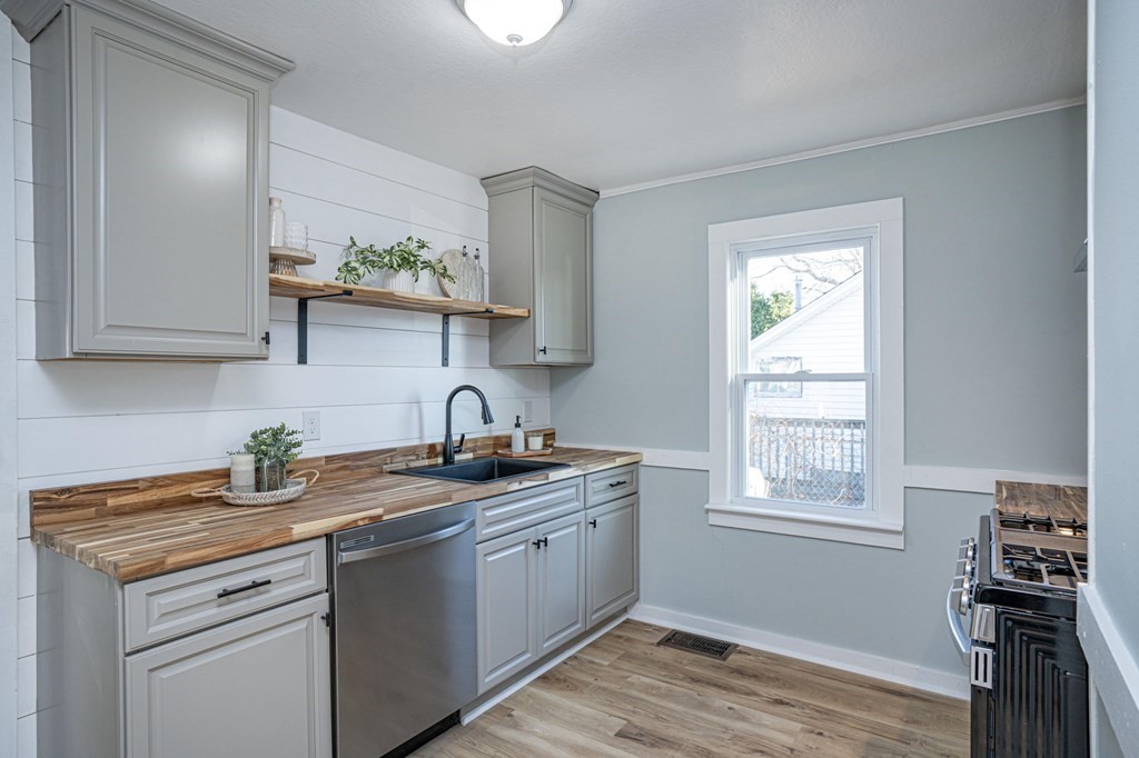 127 Pinehurst Drive Wareham, MA 02571 - Photo 25 of 40 a kitchen with stainless steel appliances granite countertop a sink a stove and wooden cabinets