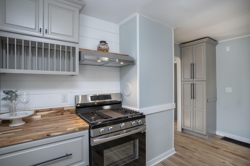 127 Pinehurst Drive Wareham, MA 02571 - Photo 27 of 40 a kitchen with stainless steel appliances granite countertop a stove and a refrigerator