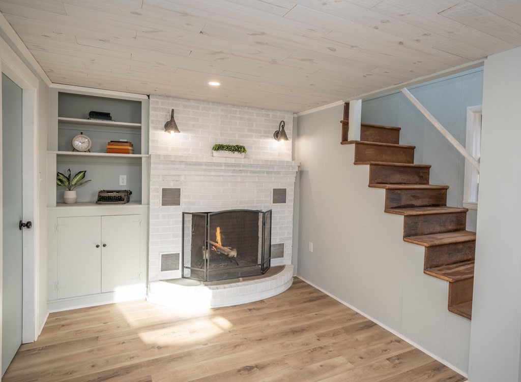 127 Pinehurst Drive Wareham, MA 02571 - Photo 31 of 40 a view of a livingroom with wooden floor and a fireplace