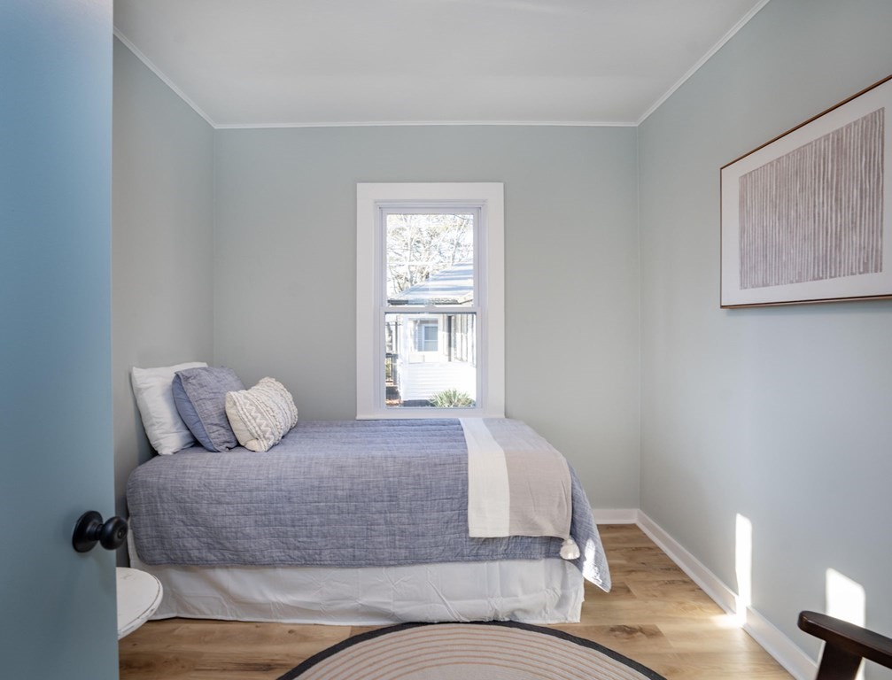 127 Pinehurst Drive Wareham, MA 02571 - Photo 9 of 40 a bedroom with a bed and wooden floor