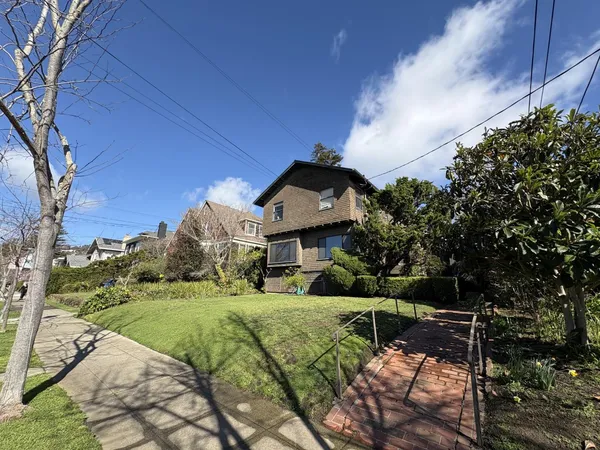 a view of house with outdoor space and sitting area
