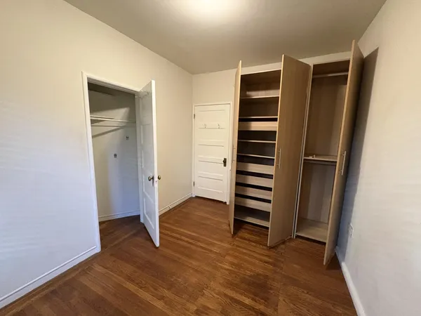 a view of walk in closet with empty racks