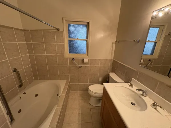 a bathroom with a sink mirror toilet and bathtub