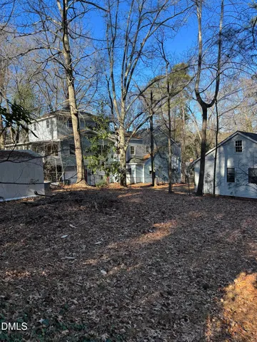 a view of a backyard with large trees