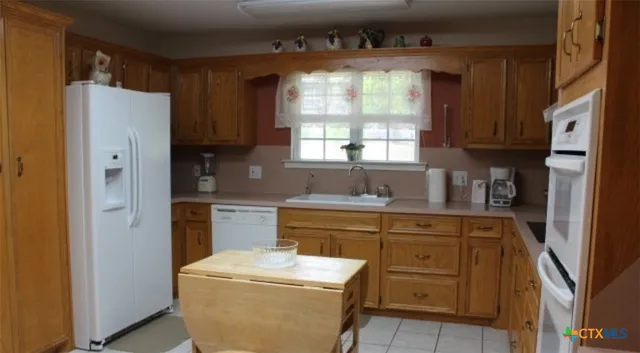 a kitchen with a refrigerator sink and window