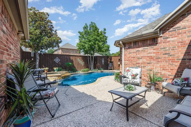 a view of a backyard with furniture and a fire pit