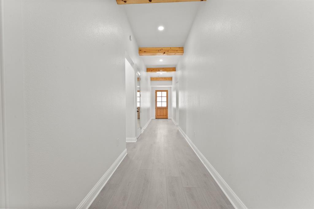 809 South Adelaide Street Terrell, TX 75160 - Photo 4 of 18 a view of a hallway with wooden floor and a window