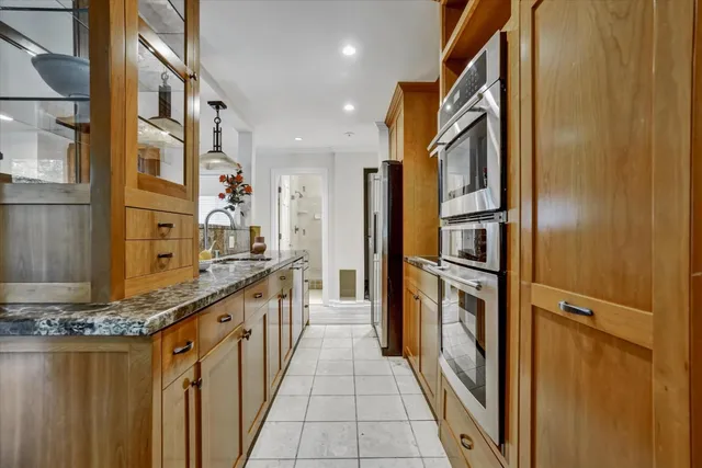 a view of a kitchen with stainless steel appliances