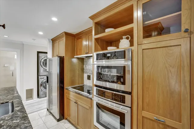 a kitchen with stainless steel appliances a refrigerator and cabinets