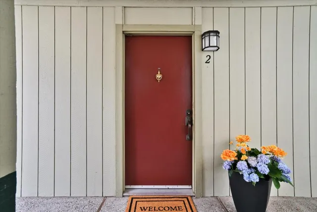 a vase with flowers sitting on a wooden floor