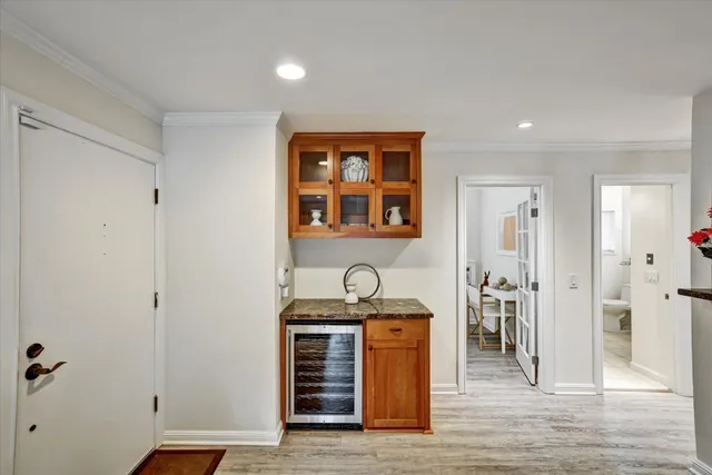 a kitchen with granite countertop a refrigerator and a sink