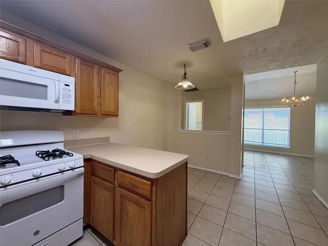 a kitchen with stainless steel appliances a stove a sink and cabinets