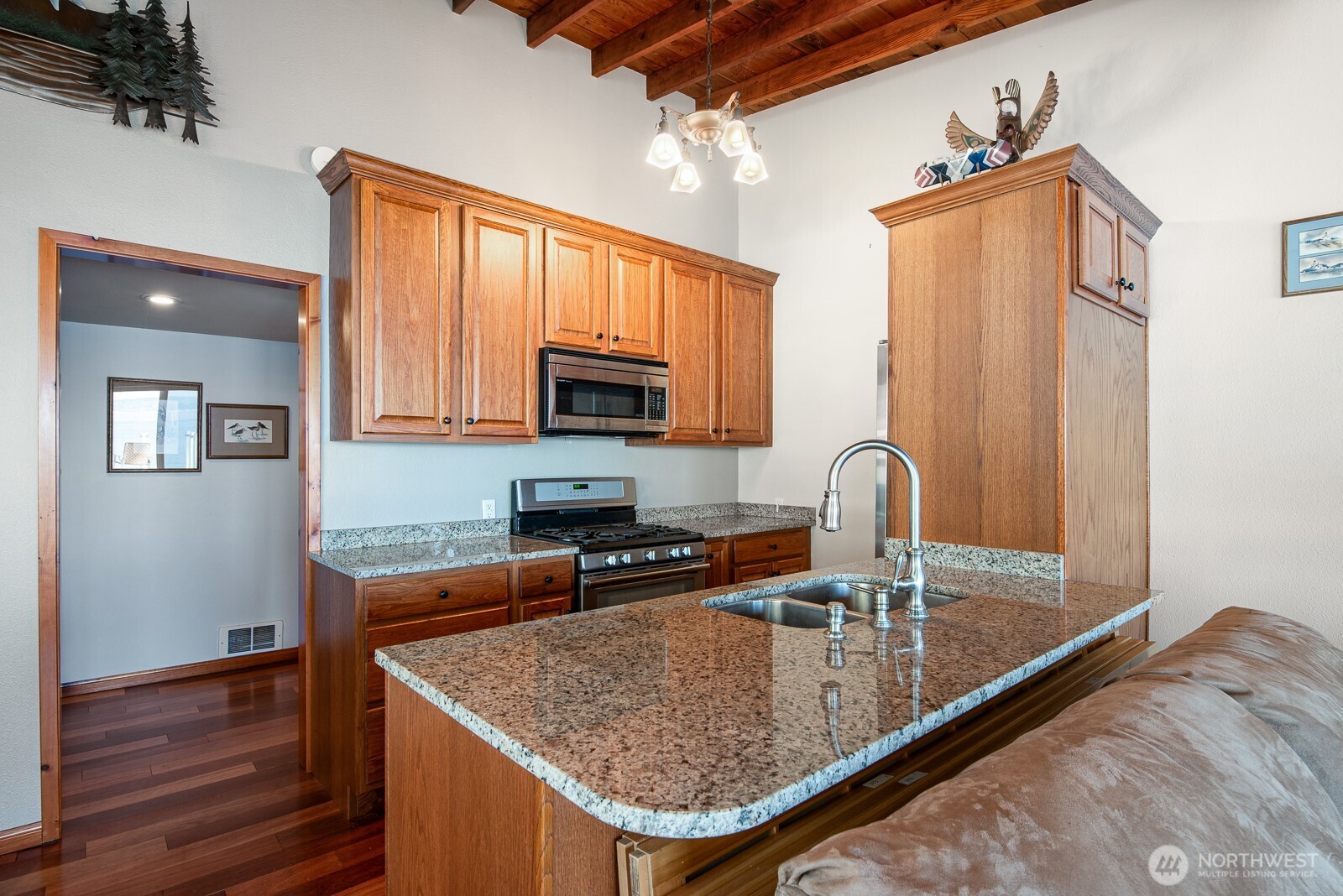 19422 Soundview Drive Northwest Stanwood, WA 98292 - Photo 12 of 33 a kitchen with stainless steel appliances granite countertop a sink a microwave and wooden cabinets