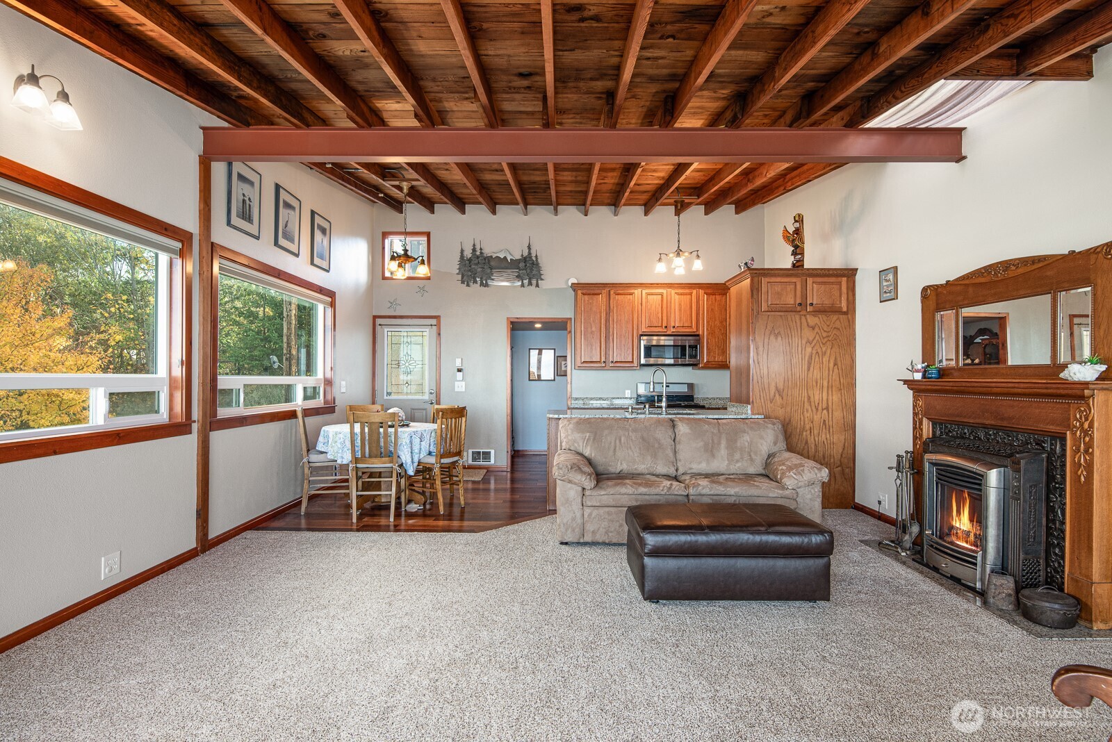 19422 Soundview Drive Northwest Stanwood, WA 98292 - Photo 14 of 33 a living room with furniture a fireplace and a table