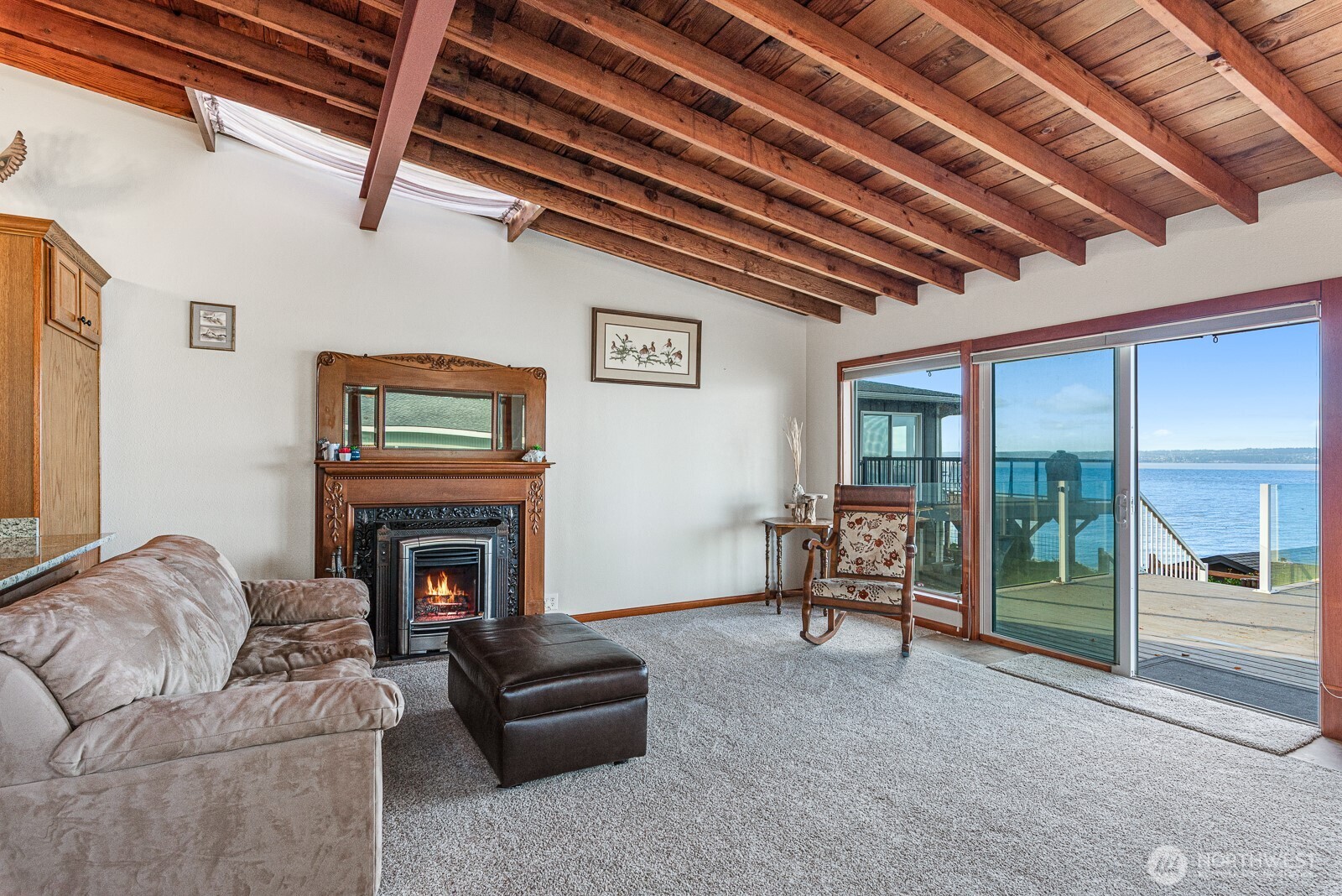 19422 Soundview Drive Northwest Stanwood, WA 98292 - Photo 15 of 33 a living room with furniture a fireplace and a flat tv screen