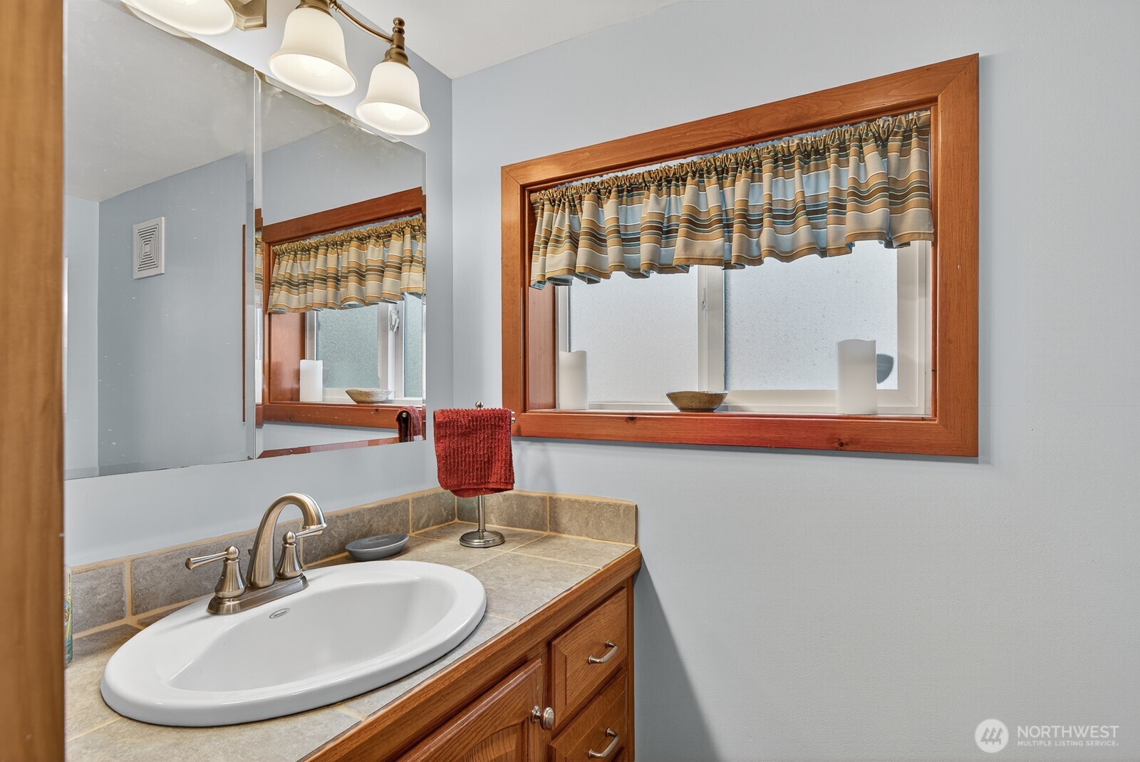 19422 Soundview Drive Northwest Stanwood, WA 98292 - Photo 20 of 33 a bathroom with a sink a vanity and a mirror