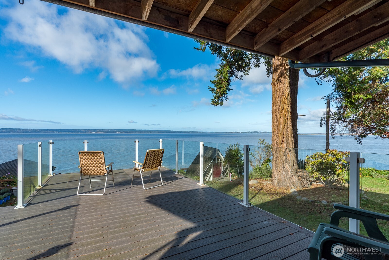 19422 Soundview Drive Northwest Stanwood, WA 98292 - Photo 24 of 33 a balcony with wooden floor table and chairs