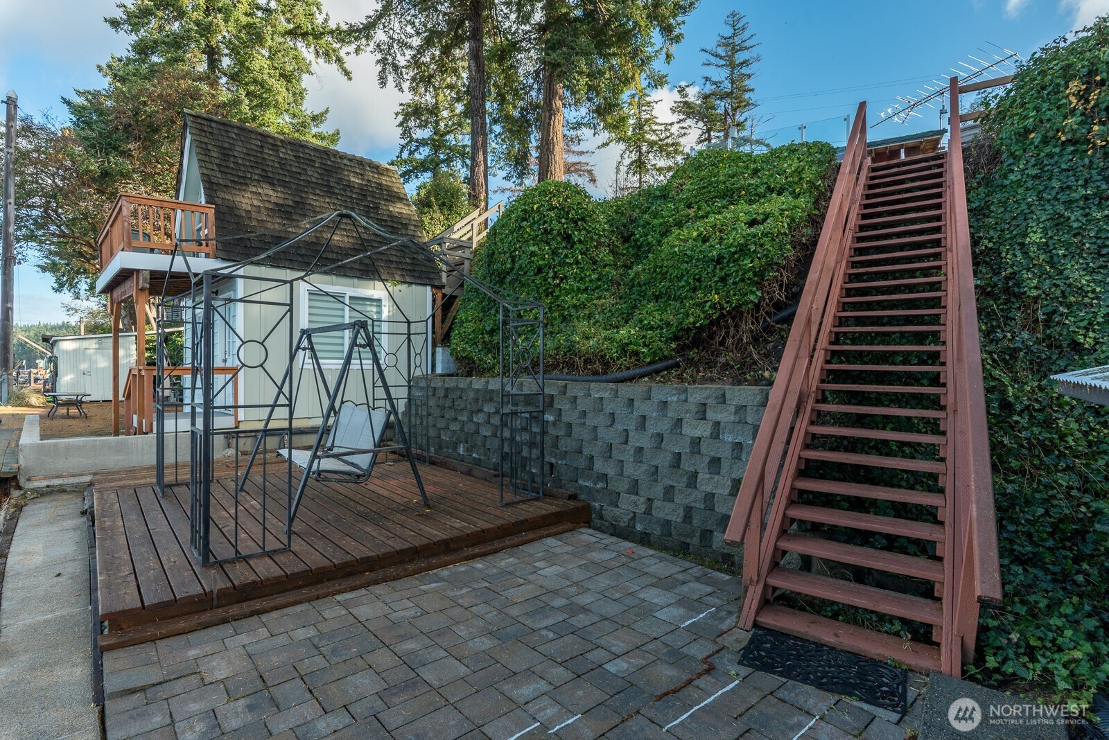 19422 Soundview Drive Northwest Stanwood, WA 98292 - Photo 27 of 33 a view of a patio with wooden floor next to a yard