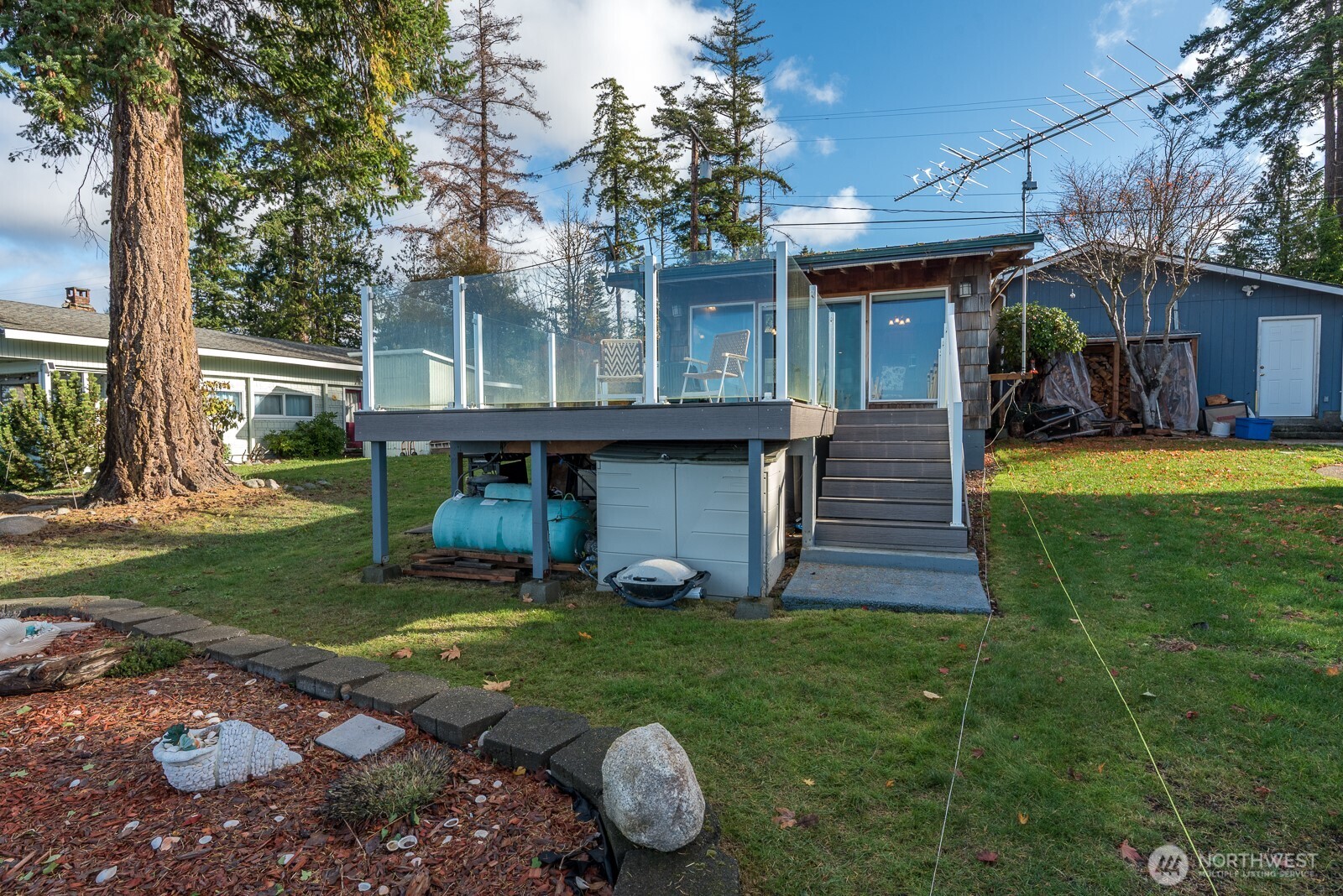 19422 Soundview Drive Northwest Stanwood, WA 98292 - Photo 31 of 33 a view of a house with backyard and a patio