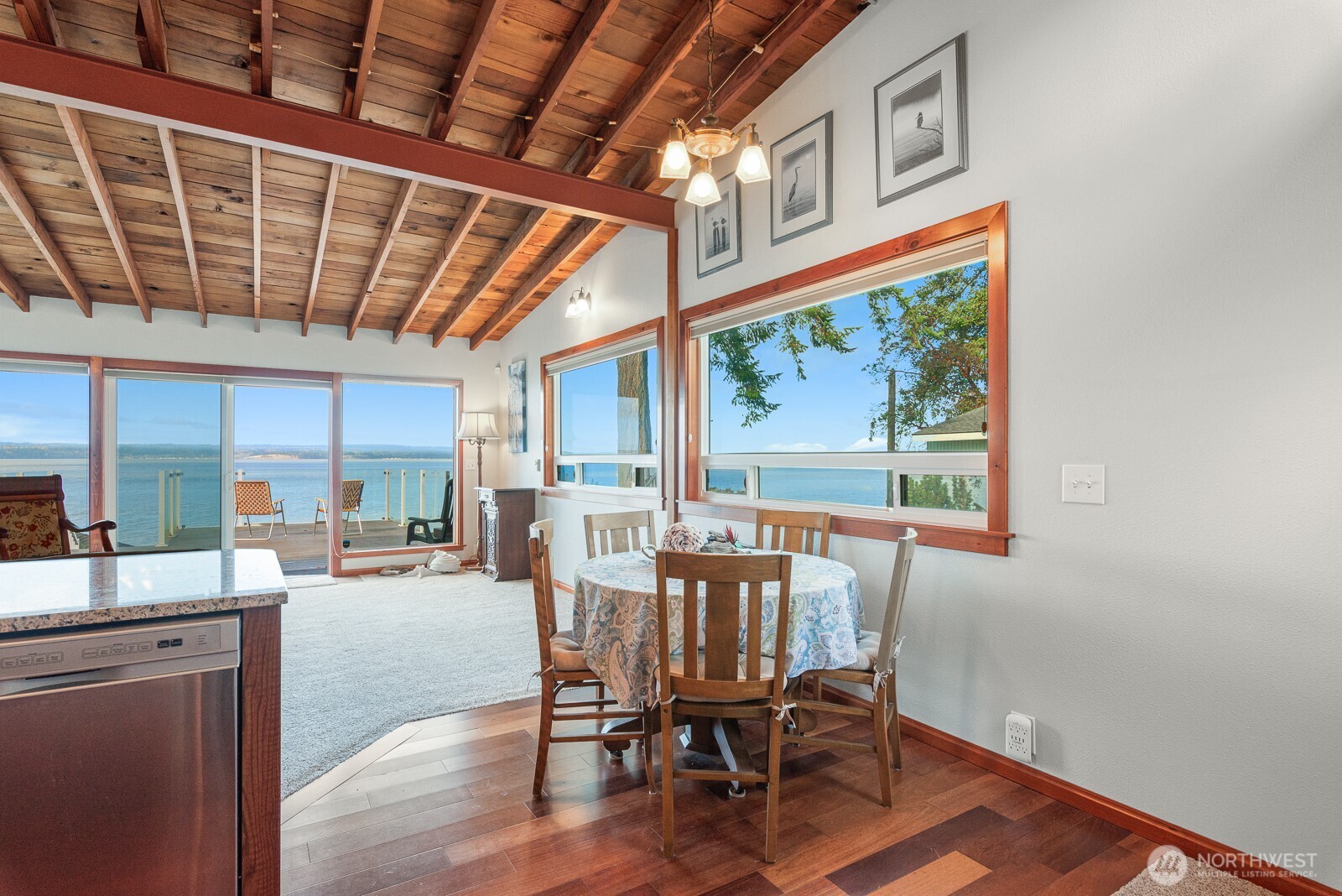 19422 Soundview Drive Northwest Stanwood, WA 98292 - Photo 9 of 33 a dining room with furniture a rug and wooden floor