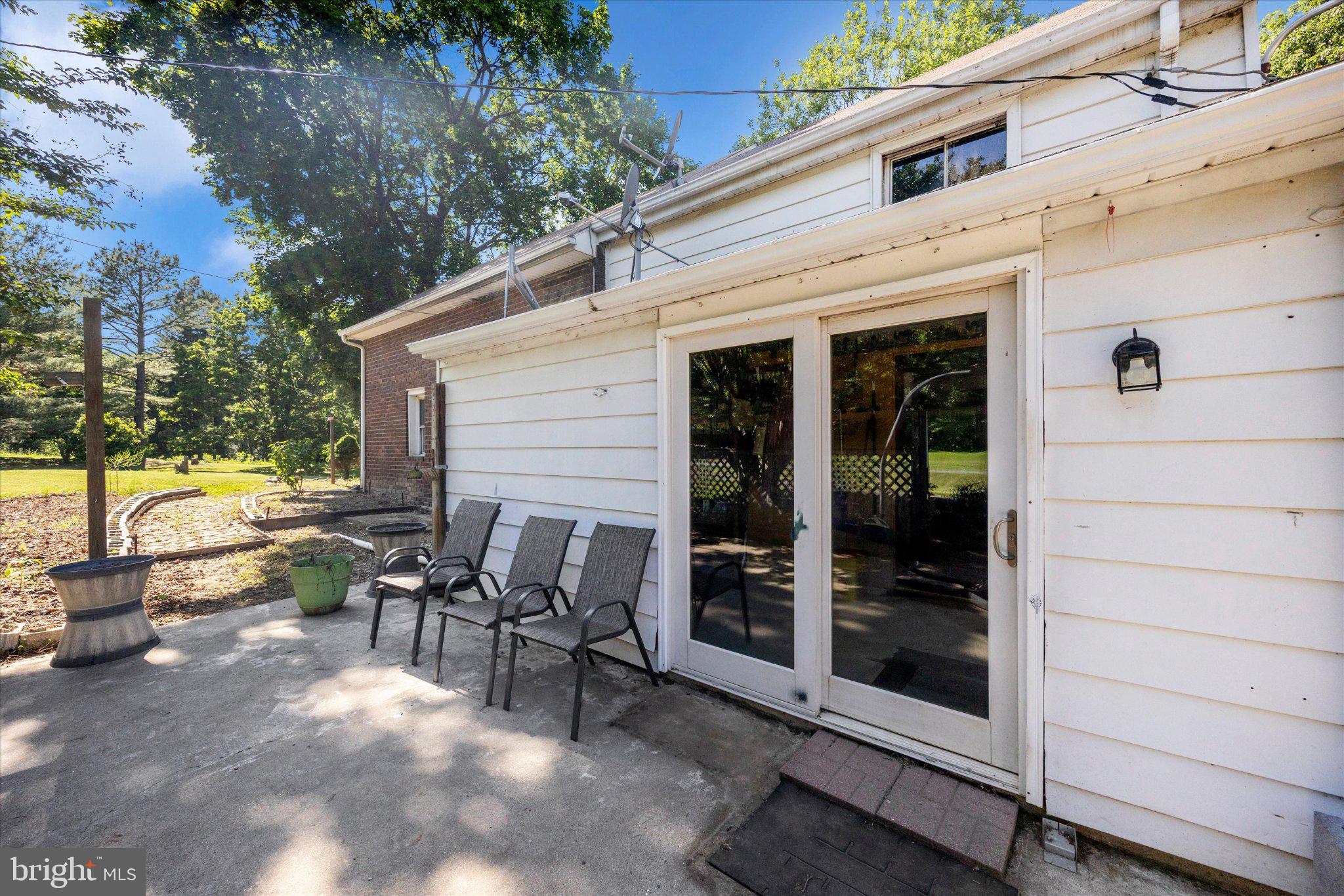 14721 Albert Staub Road Thurmont, MD 21788 - Photo 25 of 46 a view of a patio with table and chairs and floor to ceiling window